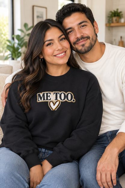 Woman wearing black Me Too sweatshirt with partner at home