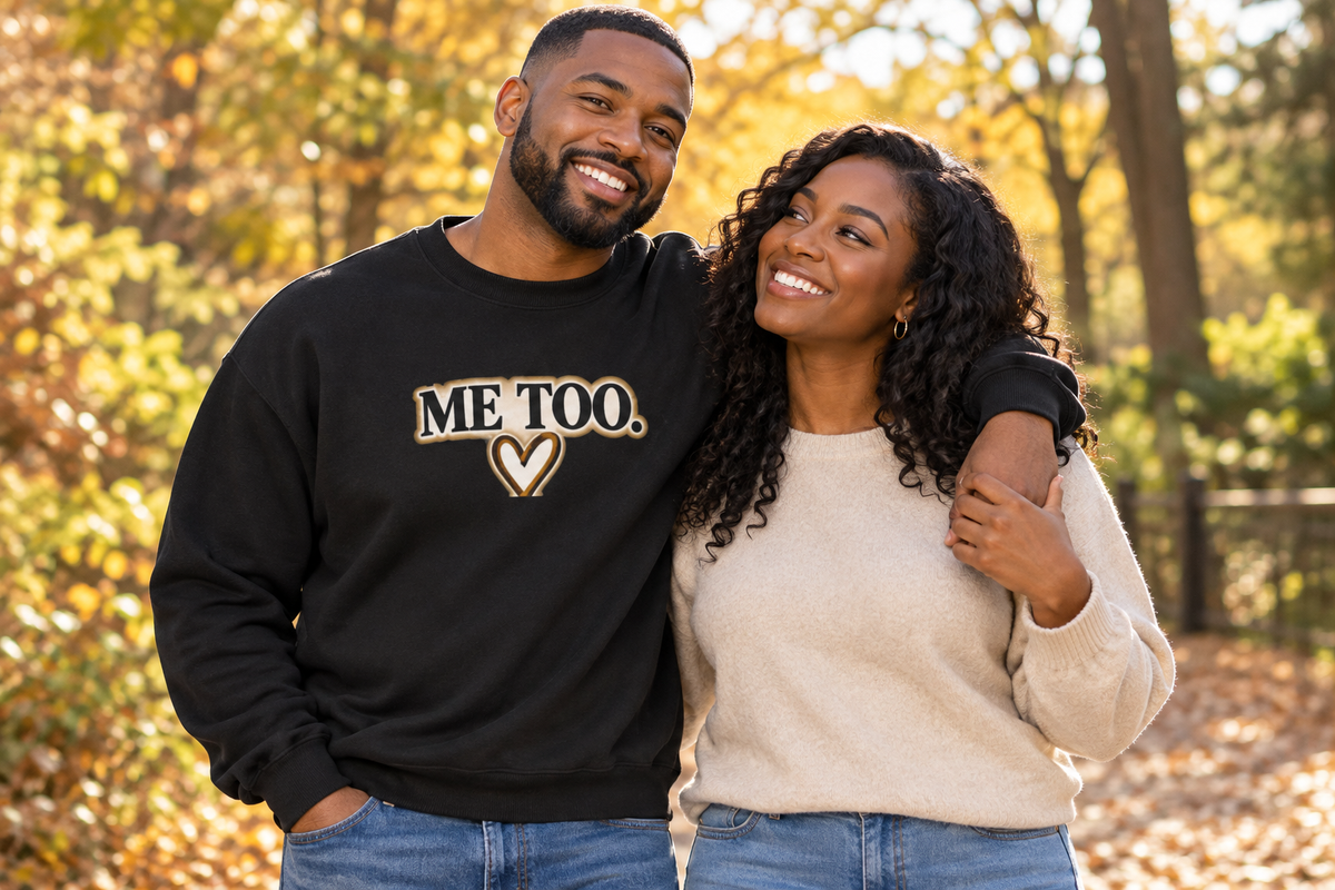 Man wearing black Me Too sweatshirt with partner outdoors